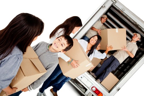 Removal van and movers in a leafy Bickley residential street